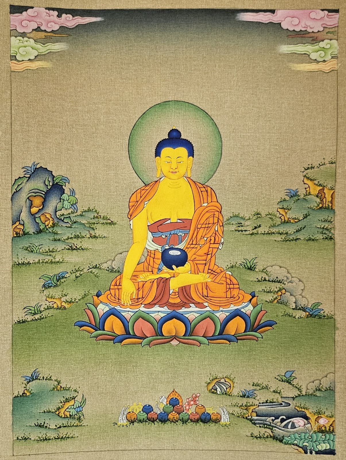 Fine outlining in black and gold defining the figure, lotus petals, and rocks